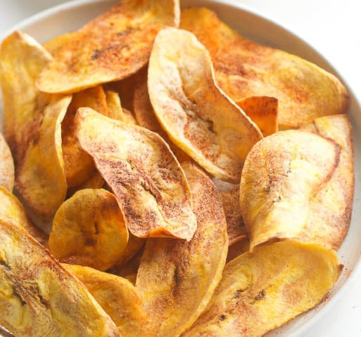 Learn how to make healthy oven baked plantain chips at home - paleo, vegan, gluten free, clean eating and whole 30 compliant. These baked plantain chips are an easy, healthy snack or side dish. You can use avocado oil or coconut oil, make them sweet or savory. These are my favorite healthy snack for satisfying my salty/crunchy cravings!