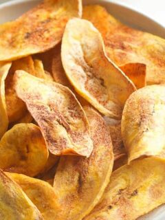 Learn how to make healthy oven baked plantain chips at home - paleo, vegan, gluten free, clean eating and whole 30 compliant. These baked plantain chips are an easy, healthy snack or side dish. You can use avocado oil or coconut oil, make them sweet or savory. These are my favorite healthy snack for satisfying my salty/crunchy cravings!