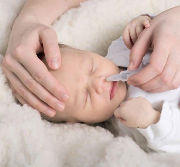 Home remedies for baby cold as saline drops for infant nose decongestant.