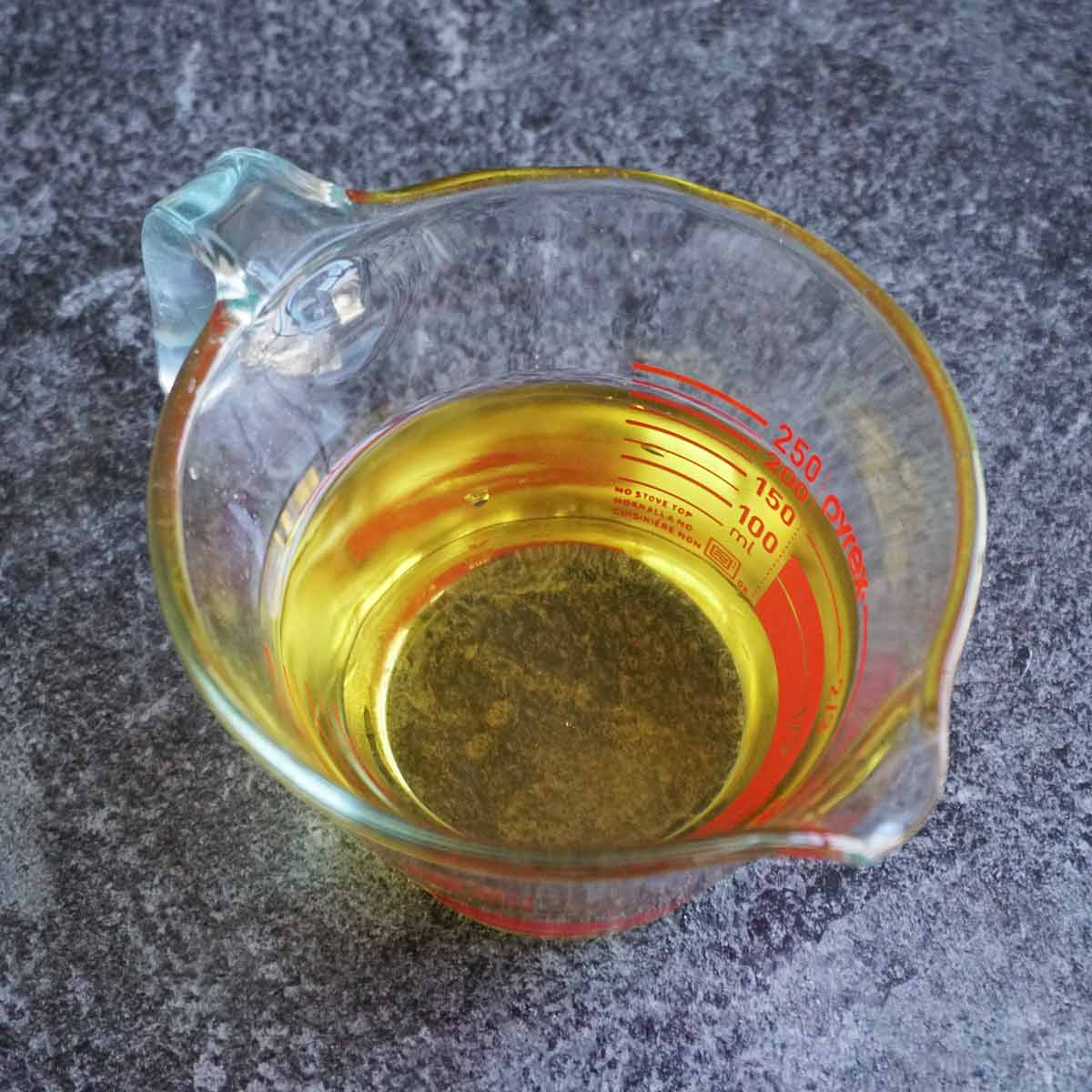 melted mango butter in a glass measuring cup before whipping
