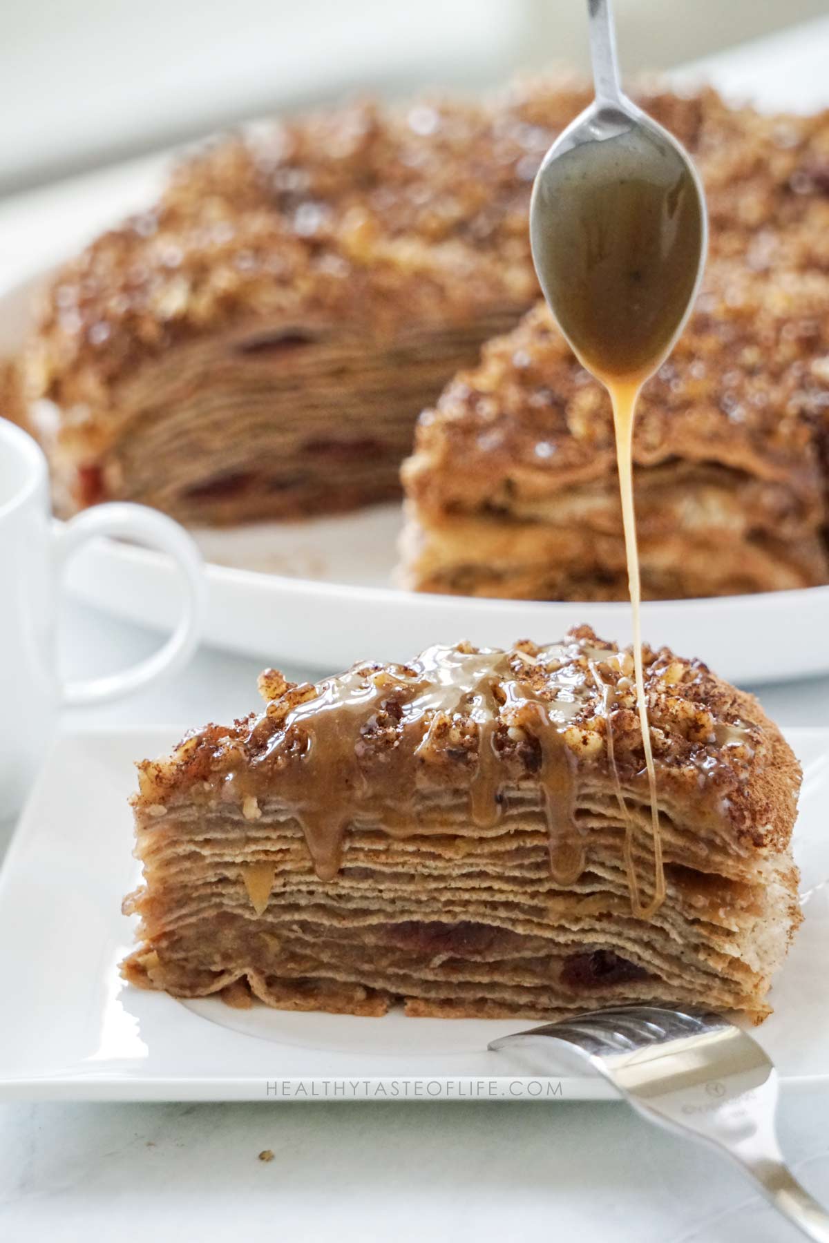 Homemade dairy free caramel sauce made with coconut cream and maple sugar drizzled over the apple crepe cake