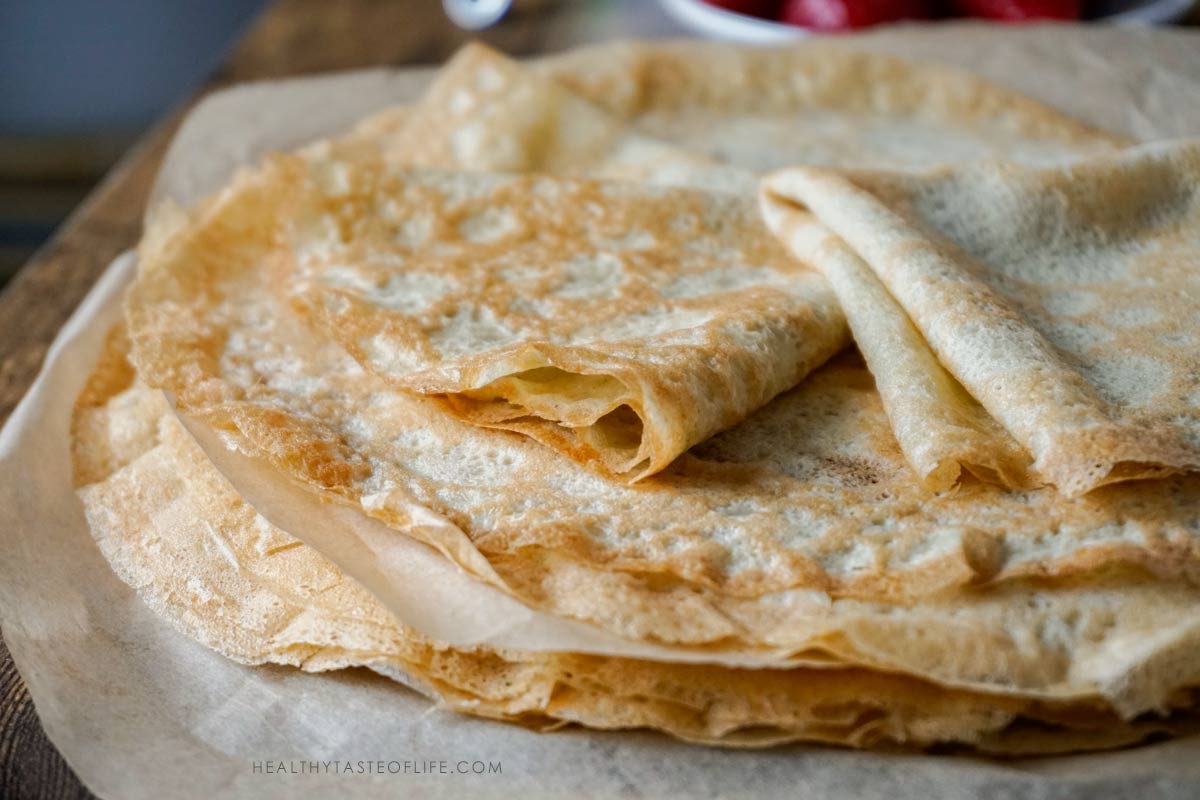Thin gluten free crepes cooked and stacked ready to be used for layered apple crepe cake
