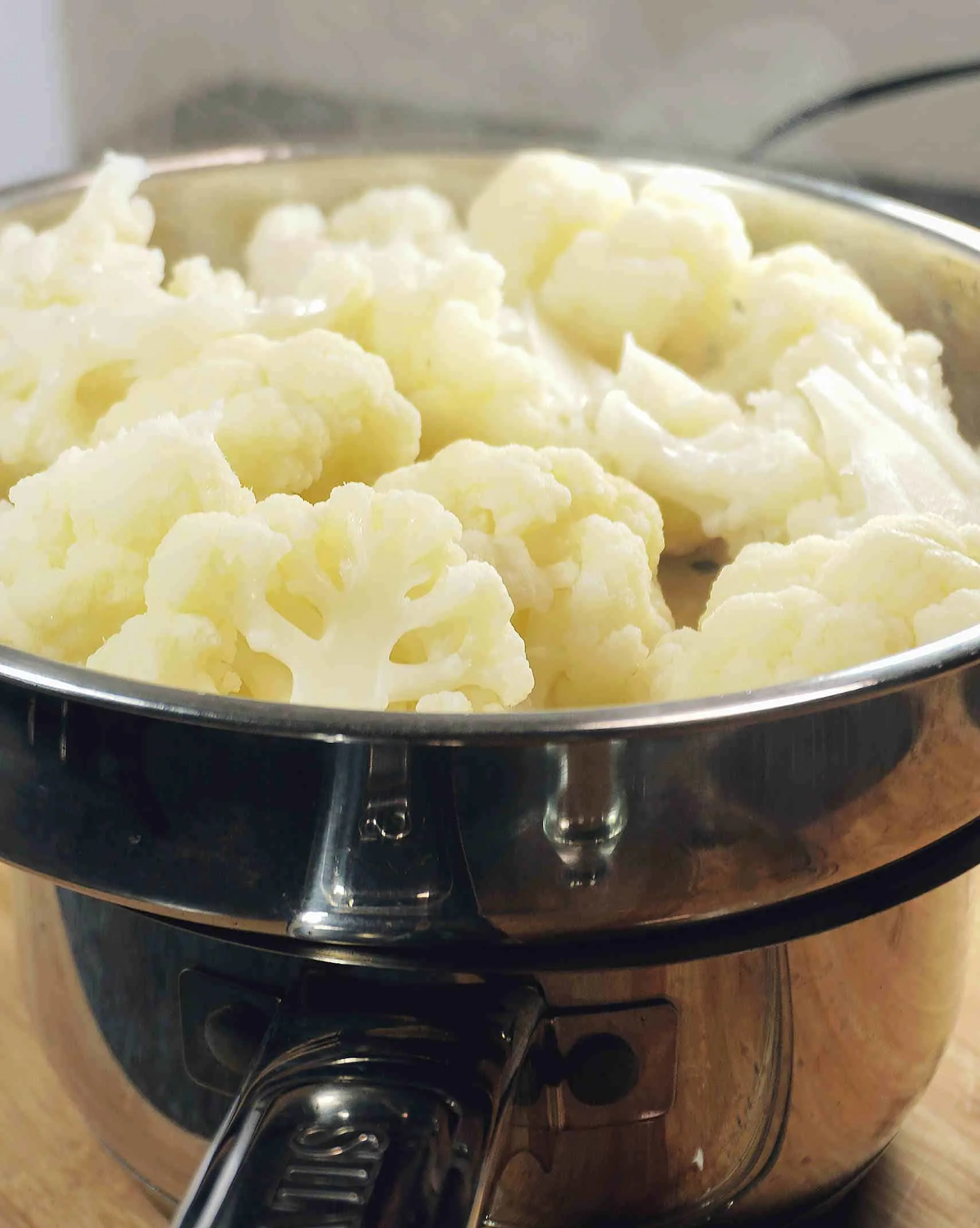 How to make cauliflower crackers or chips by steaming the cauliflower florets process shot.