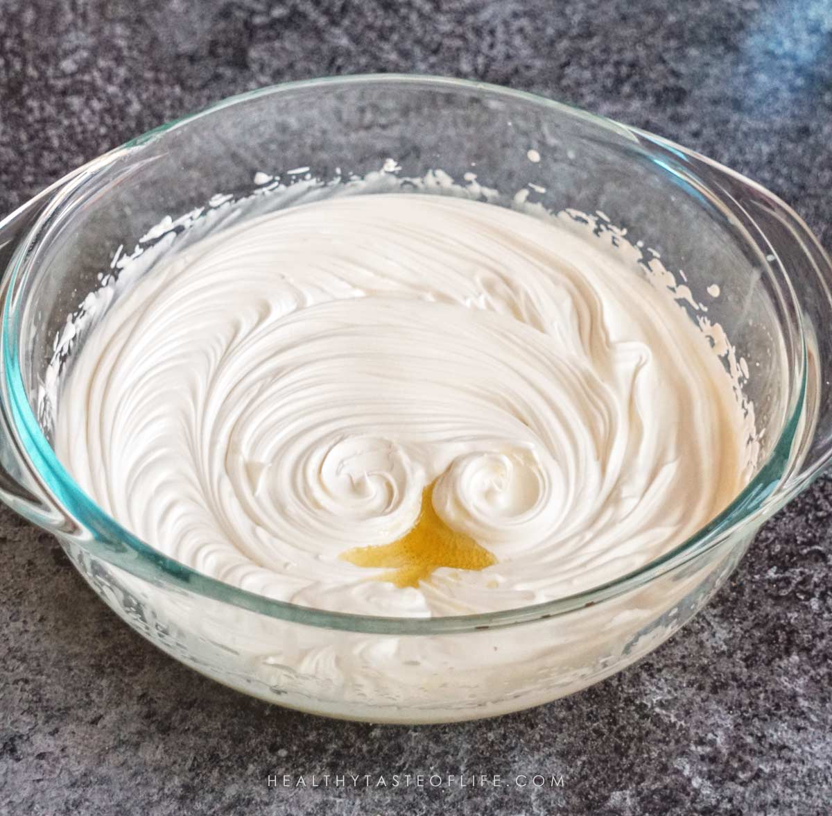 Essential oils (chamomile and rose) added to the homemade moisturizer for dry skinl last step before a final whip.