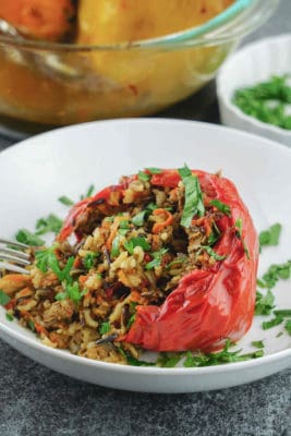 Healthy stuffed peppers – a comforting gluten free, dairy free, sugar free,clean eating recipe great for dinner or lunch. The bell peppers are stuffed with a mix of wild rice and long grain rice, organic grass fed ground beef, caramelized veggies, aromatic herbs, spices and baked in the oven until moist and tender.