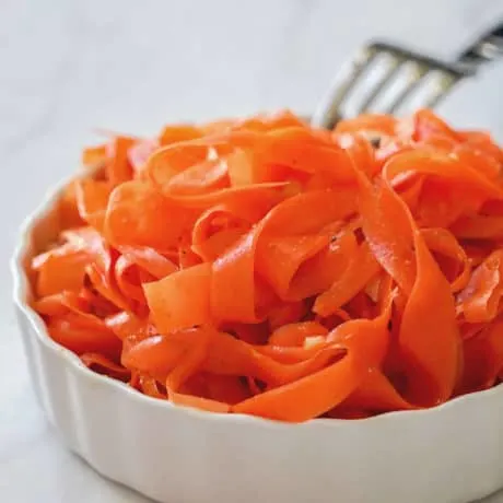 A very easy and healthy Paleo, Whole 30, and Vegan Carrot Salad made with fermented shaved carrots and a mix of spices. A probiotic-rich, tangy and fragrant carrot salad that can be served as a side dish or topping.