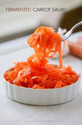 Lacto Fermented Carrot Salad Recipe – fermented shaved carrots with garlic and coriander flavor – learn how to make probiotic-rich, tangy and fragrant carrot salad that can be served as a side dish, topping for tacos, burgers, and even more!