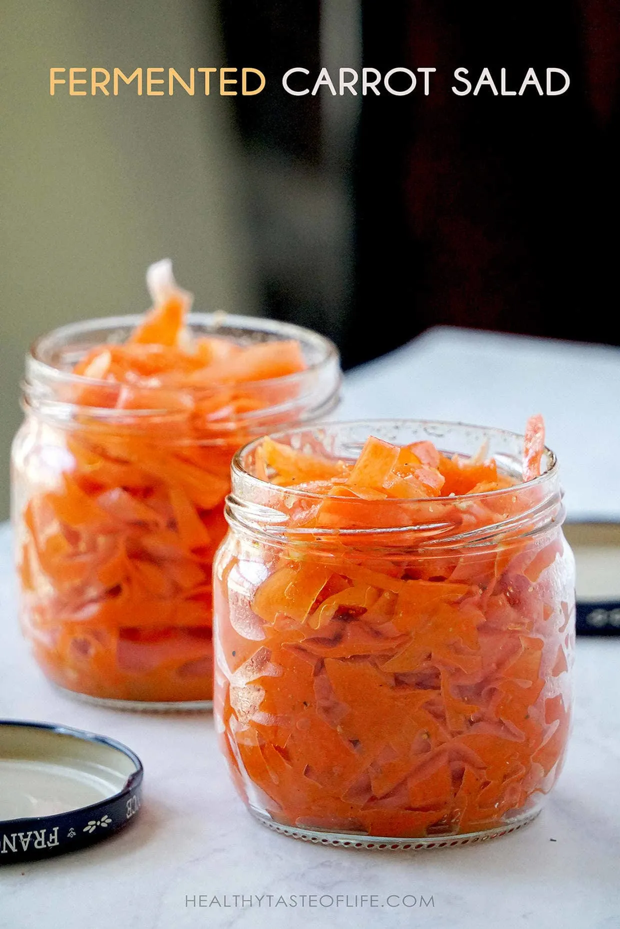 Storing shaved fermented carrots in the jar.
