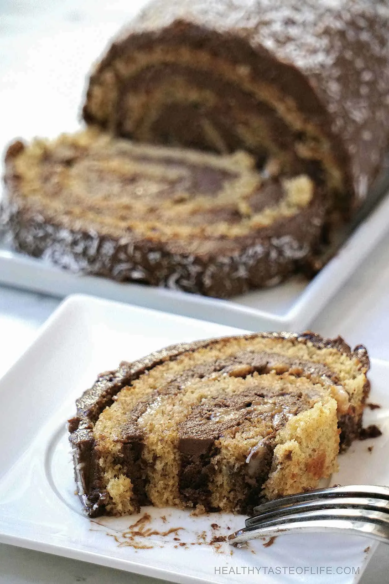 Gluten free Paleo swiss roll cake recipe with a dairy free carob frosting /filling (a chocolate substitute) enhanced with coffee flavor. This gluten free roulade cake is easy to make, it’s also grain free, refined sugar free (low sugar) and great as a paleo dessert. 