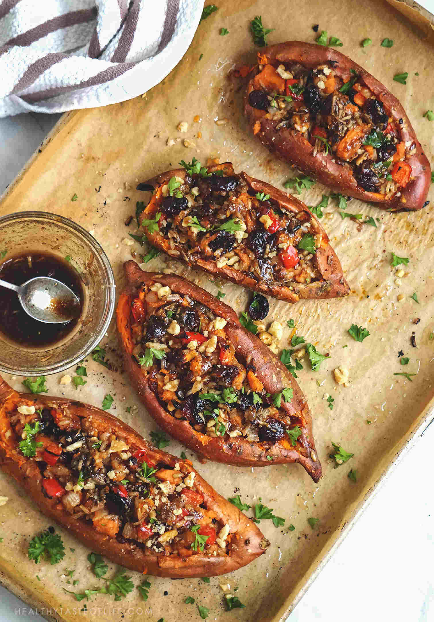 These Baked Stuffed Sweet Potatoes make a great, filling, healthy dinner, lunch, breakfast or side dish recipe for your Thanksgiving table. Loaded Baked sweet potato skins baked to perfection and then stuffed with the most delicious rice based vegan filling - with sweet and savory notes. A perfect healthy holiday side dish – vegan, gluten free, dairy free, clean eating recipe.