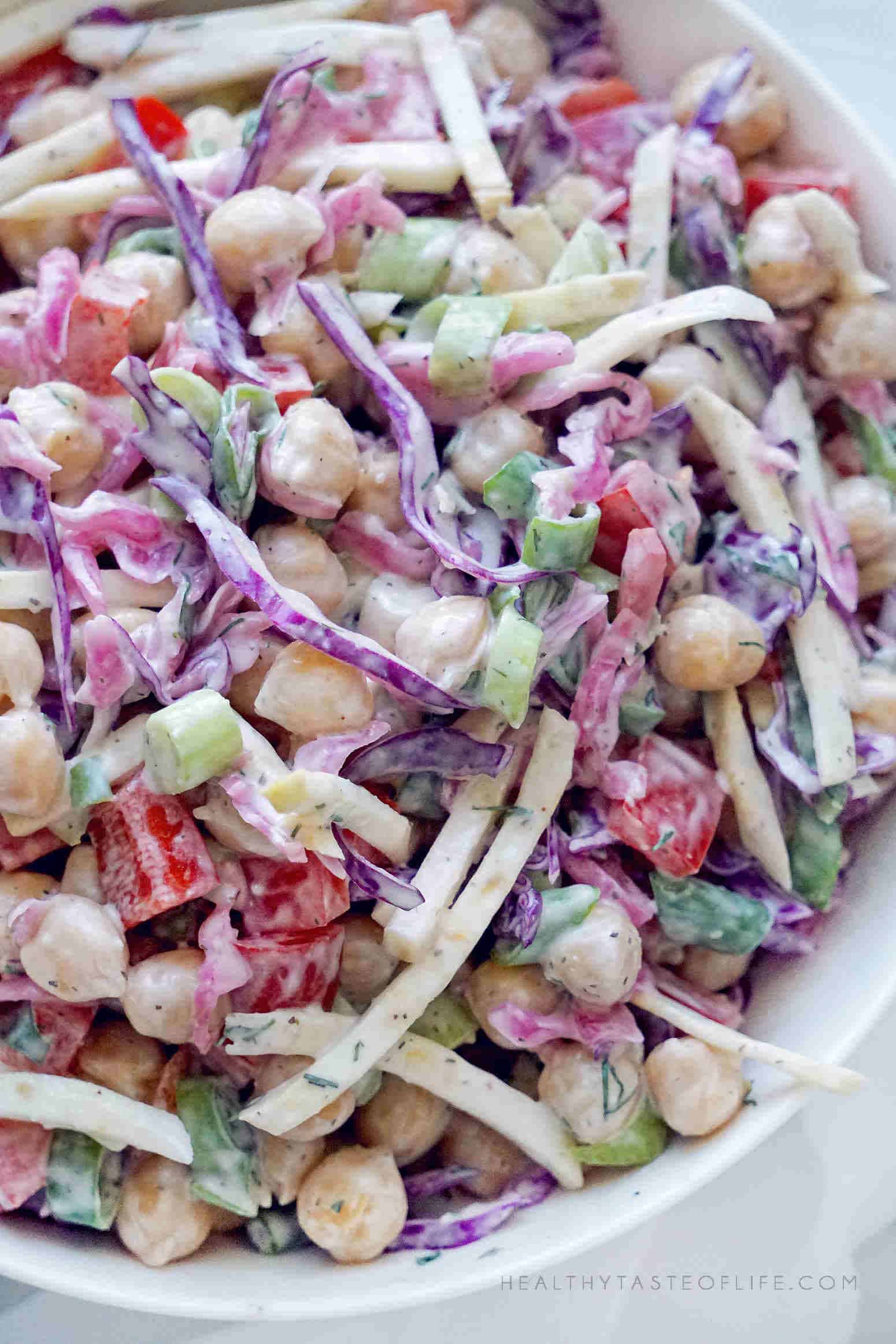 Assembled chickpea salad with cabbage and veggies tossed with a creamy dressing.