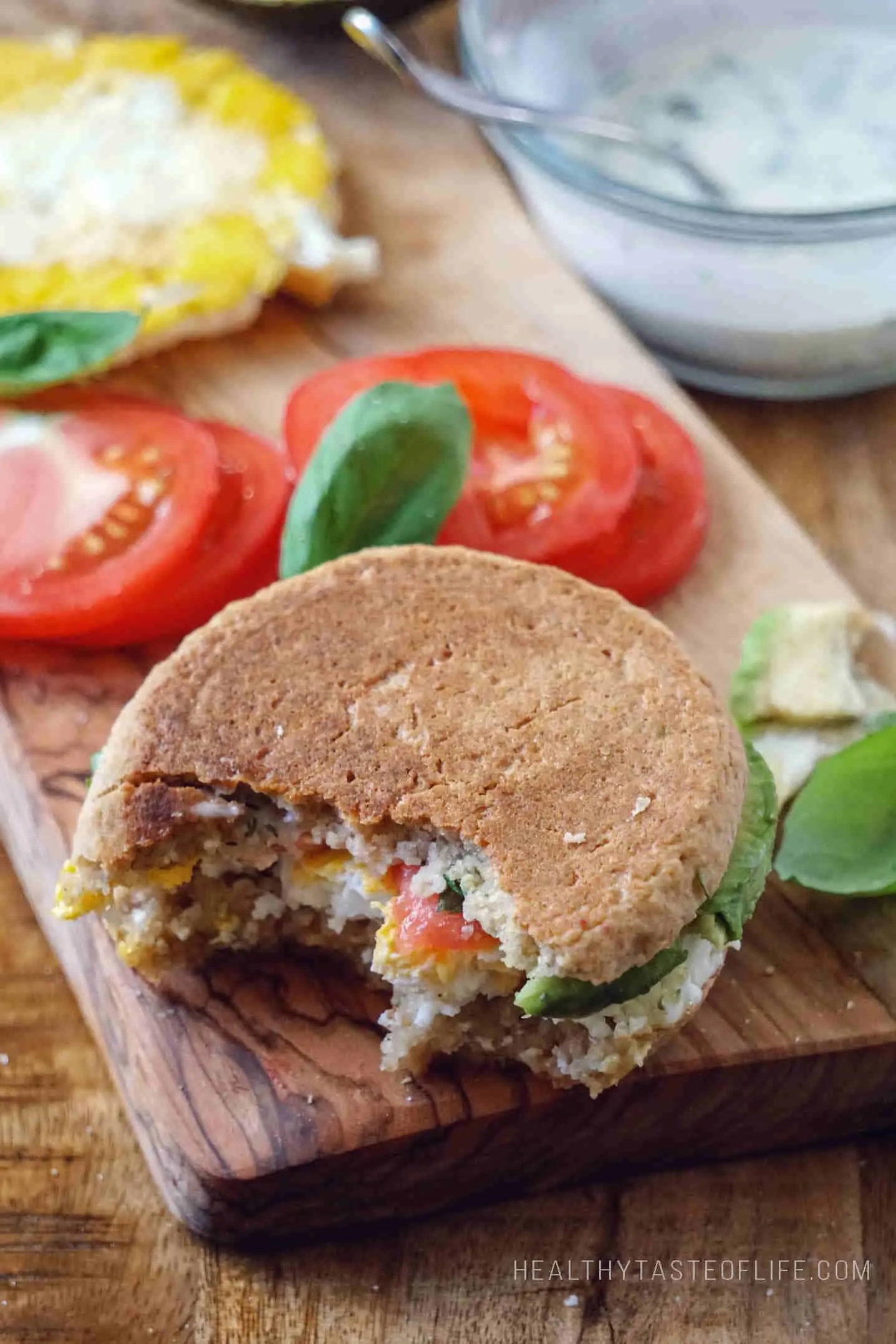 Skinny gluten free English muffin sandwich: avocado, tomato, fried egg, fresh basil and dairy free ranch dressing  