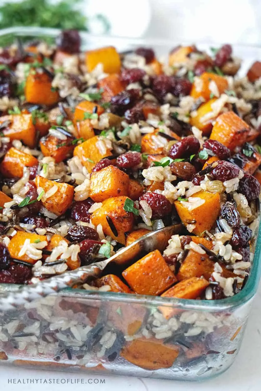 Butternut squash casserole recipe  with roasted sweet potatoes, butternut squash, cranberries, raisins complemented by earthiness of brown rice and wild rice and finished with balsamic sauce. A healthy side dish or meal during fall or holiday season (Thanksgiving or Christmas).
