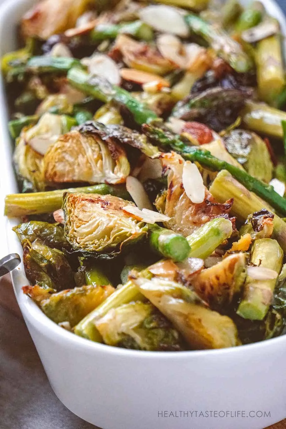 Crispy Brussels sprouts recipe roasted in the oven that yield wonderful toasty flavored Brussels sprouts combined with asparagus finished with a sweet Dijon mustard sauce. A simple healthy crispy Brussels sprouts recipe perfect as a special meal or side dish for Christmas dinner. Fresh or frozen Brussels sprouts they both will work! #roasted #crispy #easy #bruselsprouts #recipes