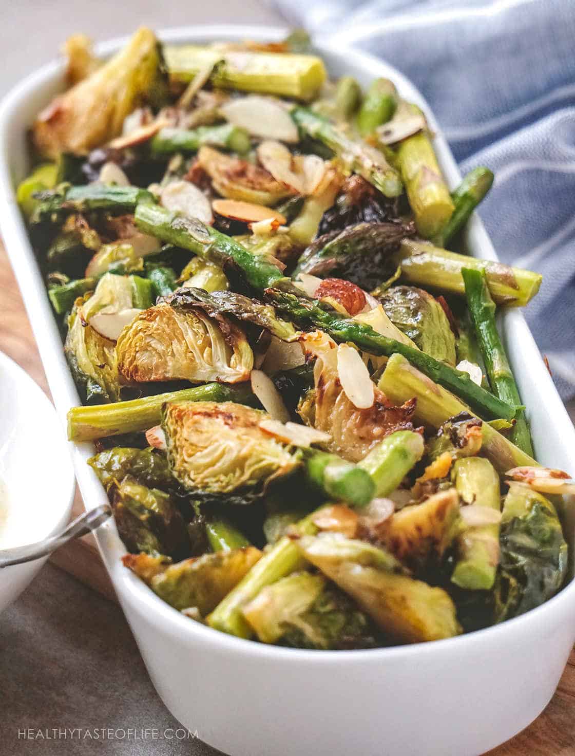 Looking for Healthy Vegan Brussels Sprouts Recipes to serve as a side dish or dinner? Check out this easy oven roasted Brussels sprouts recipe with asparagus and toasted almonds – all crispy served with a sweet and tangy mustard sauce. Perfect for Thanksgiving and Christmas holiday table. #brusselssprouts  #vegan  #sidedish  #holidaysidedish #brusselsprouts
