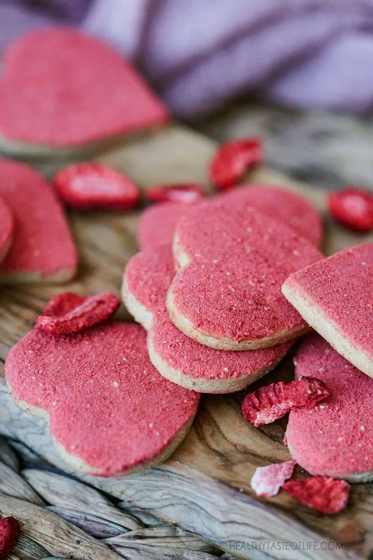 Vegan Valentines Cookies  - heart shaped vegan sugar cookies with freeze dried strawberry. #veganglutenfreecookies #valentinesugarcookies #valentinesdessert