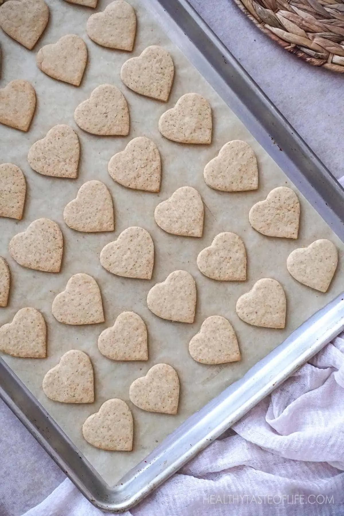Healthy Vegan Gluten Free Heart Shaped Cookies on a baking sheet.
