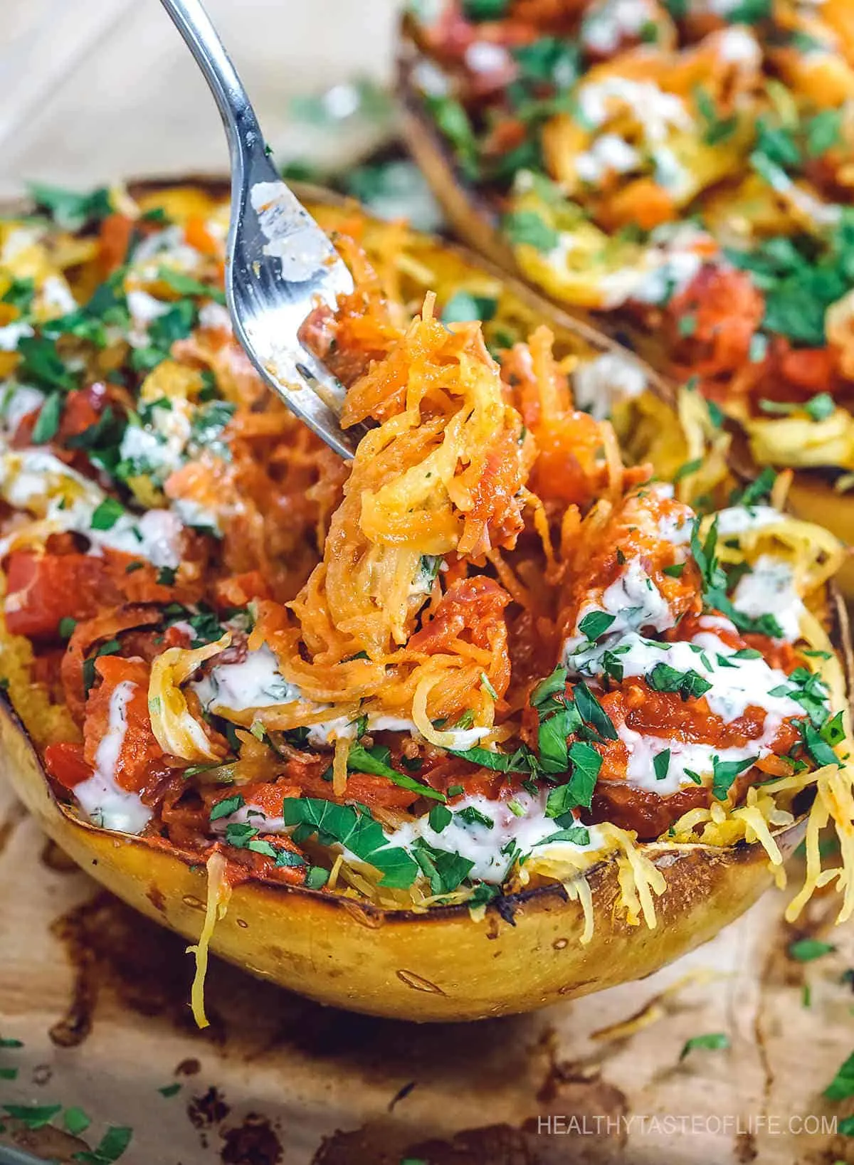 Healthy chicken spaghetti squash recipe – baked in the oven until caramelized, stuffed with shredded chicken breast and tossed together in a vibrant BBQ sauce – a delicious lunch or dinner made with only whole foods. This healthy chicken spaghetti squash boats are also keto, low carb, whole30 and paleo friendly! See video and printable recipe. #lowcarbspaghettisquash #healthyspaghettisquash #spaghettisquashboats #healthyspaghettisquashrecipe #chickenrecipes