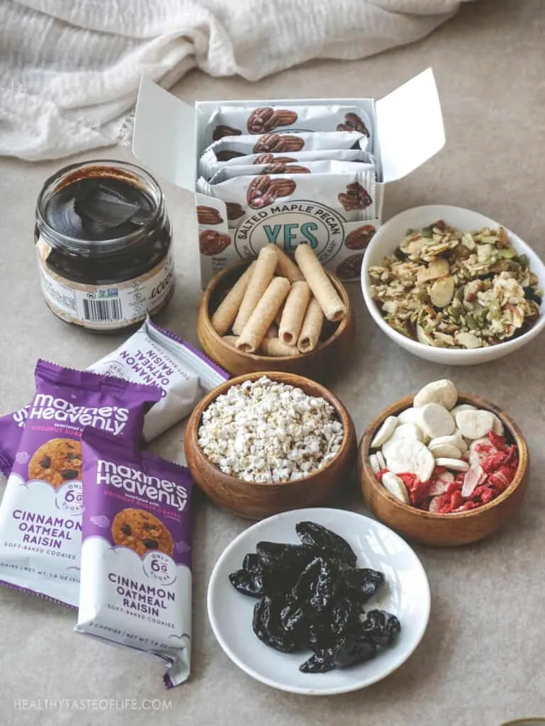 Dairy free snacks and gluten free snacks cookies dried fruit granola, crunchy rolls date and cacao spread sorghum popcorn and freeze dried fruit.