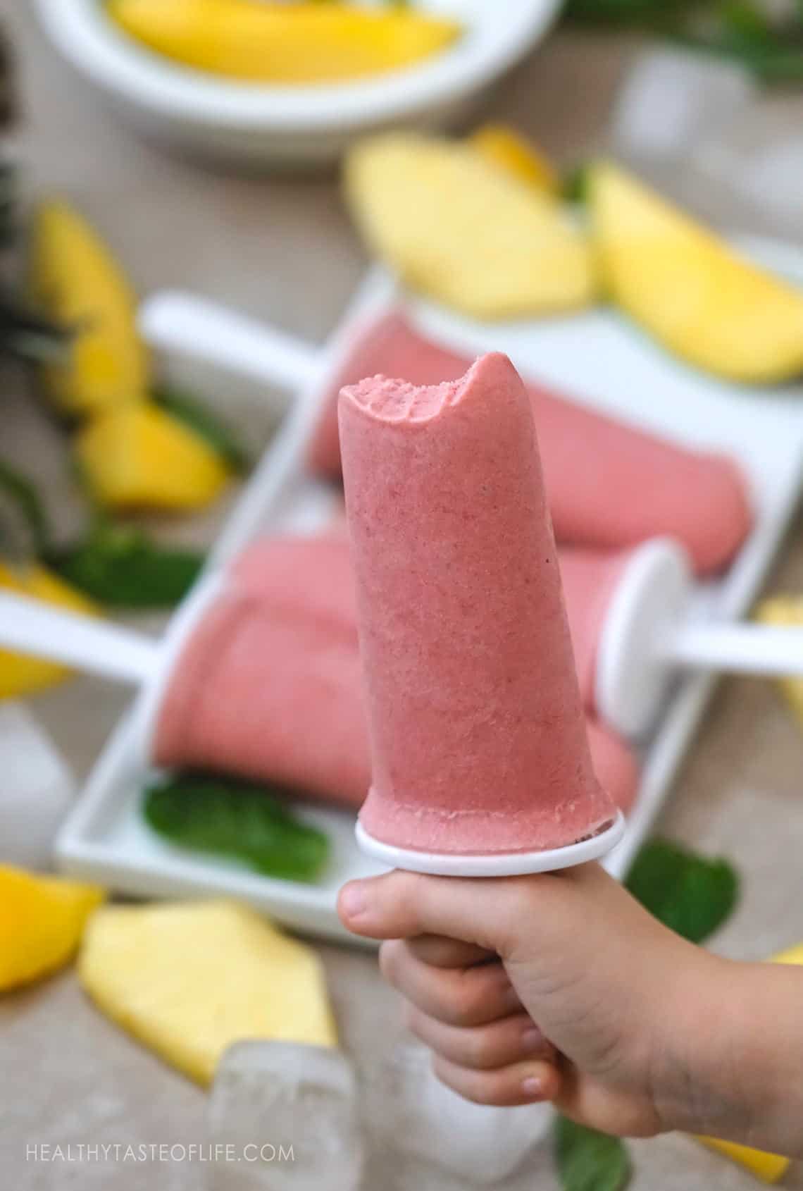 Creamy sugar free popsicles made with whole tropical fruits. Tropical ice pops or popsicle perfect for kids and adults. #popsicles #icepops #fruitpops #healthypopsicles