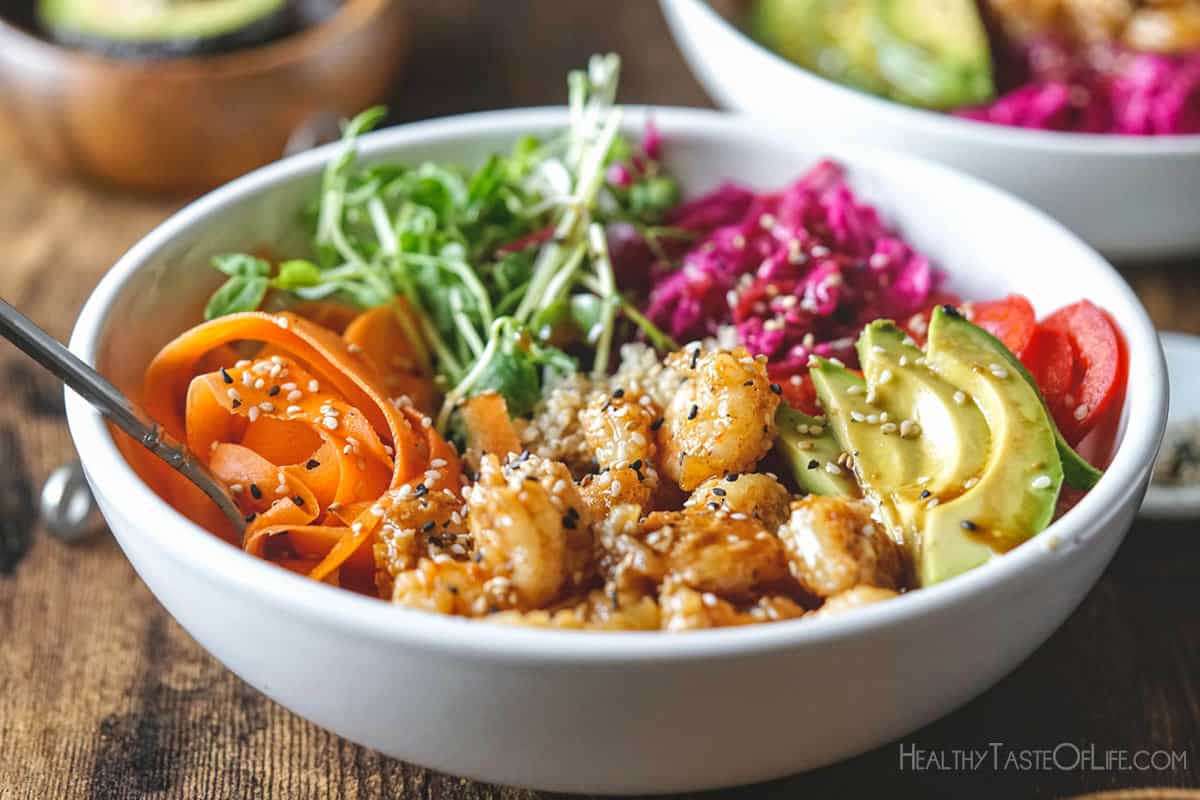 Quinoa poke bowl with shrimp and fresh vegetables, sauerkraut and soy free poke sauce.