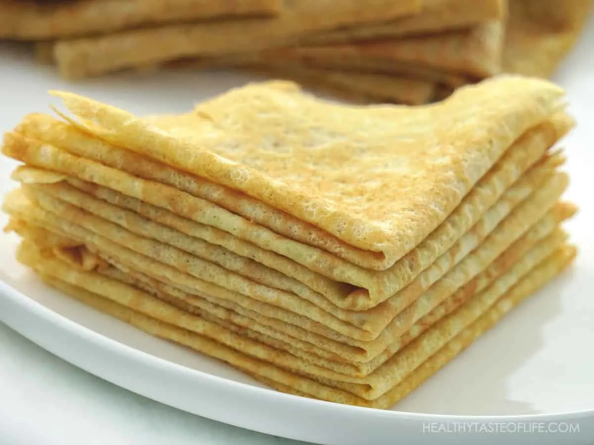 Grain free low carb crepes with almond flour and banana flour stacked on a plate.