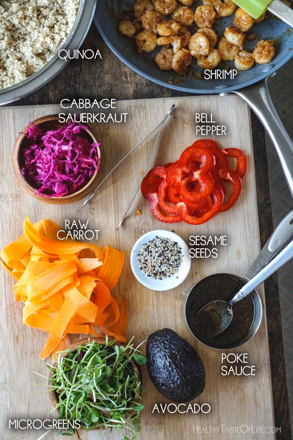 Ingredients for shrimp and quinoa poke bowl on a board.