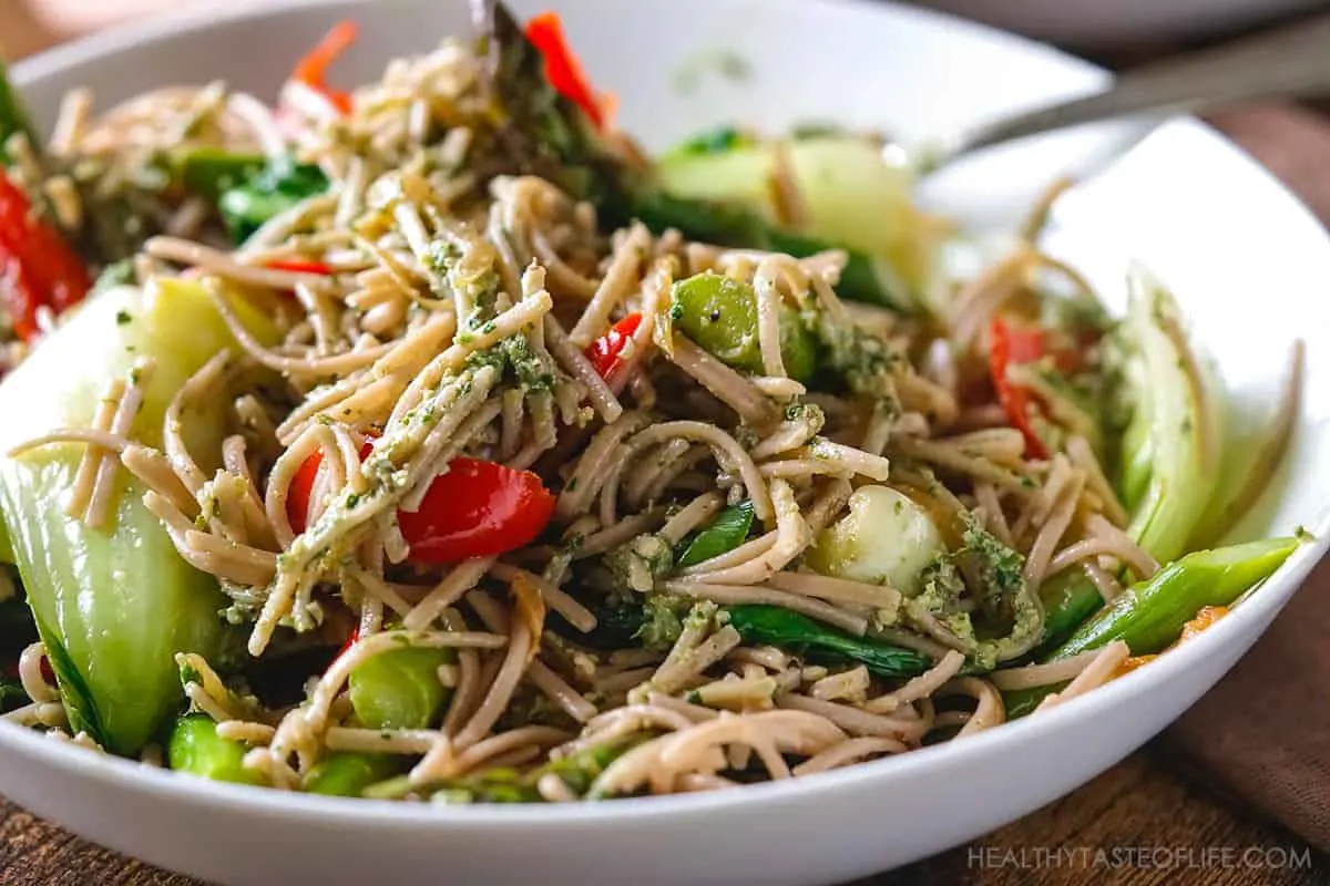 Gluten free buckwheat soba noodles recipe with vegetable stir fry finished with pesto sauce.