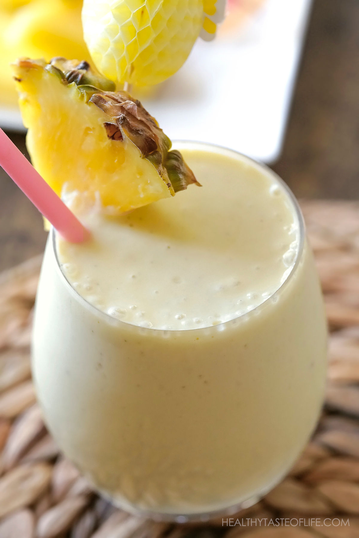 Close up shot of pineapple milkshake in a glass.
