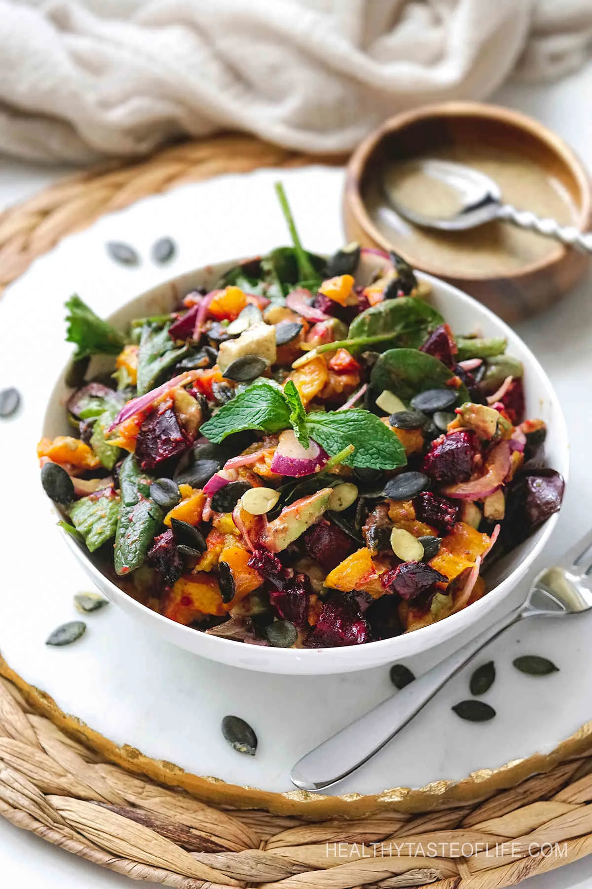 Pumpkin and beetroot salad with roasted veggies and dressing.