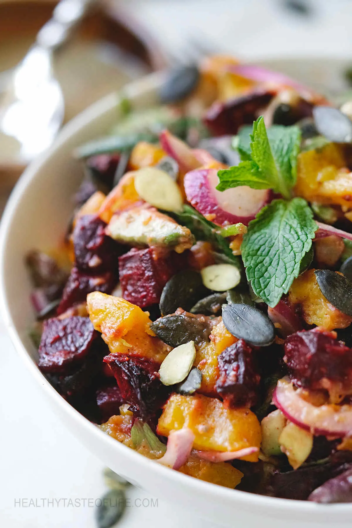 Roast pumpkin and beetroot salad with dressing.