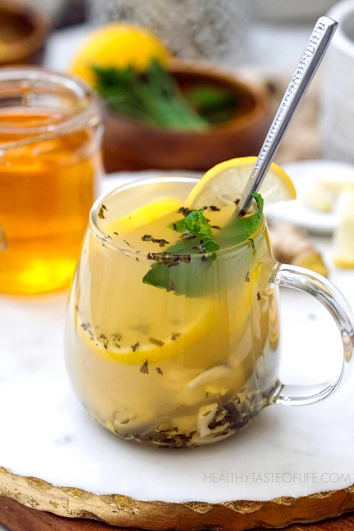 An immune booster drink called flu bomb drink with lemon honey ginger garlic. A cup of best tea for cold and flu.