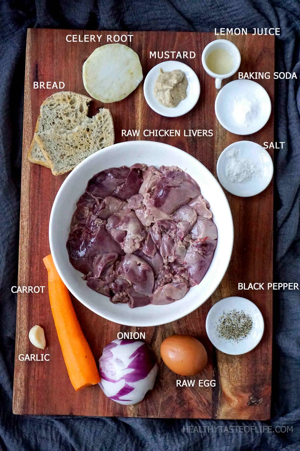 Ingredients for chicken liver patties displayed on a board.