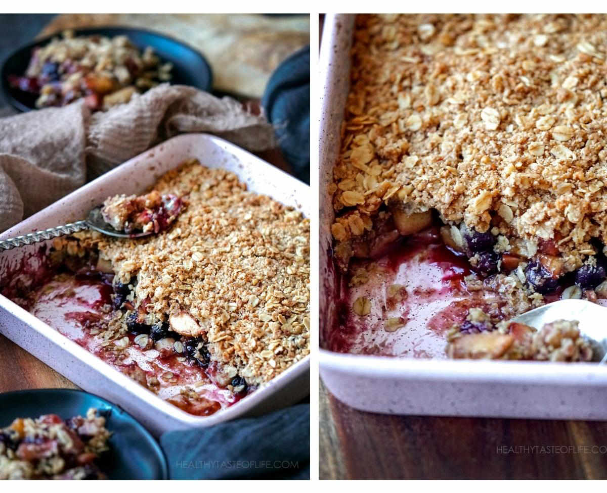 Baked apple and blueberry crumble ready to eat with a spoon.
