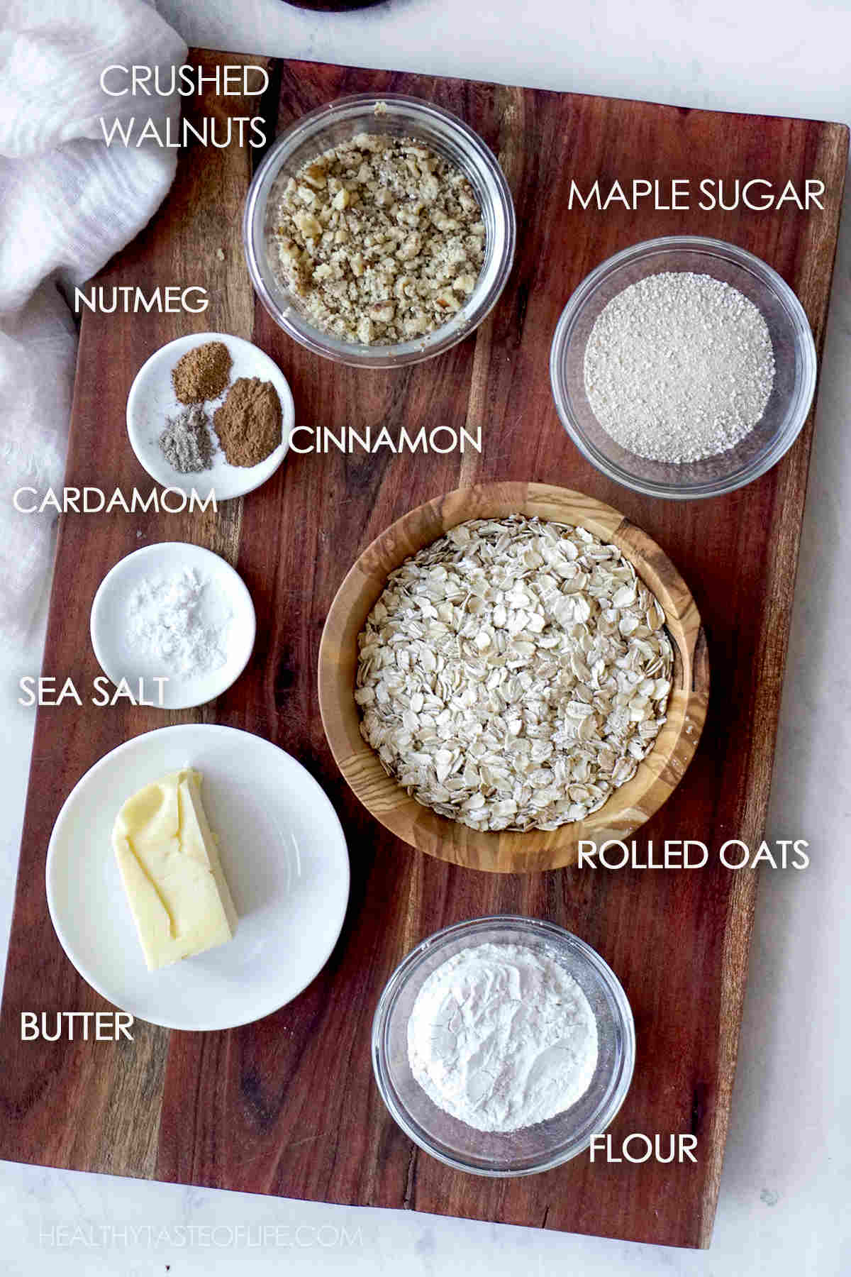 Ingredients for oat crumble topping displayed on a board.
