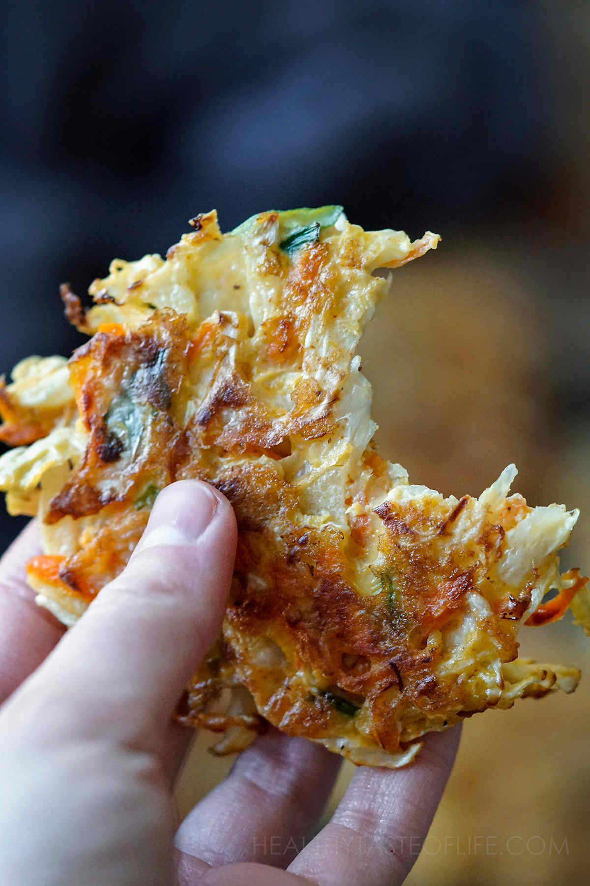 Close up shot of a cabbage fritter held in my hand.