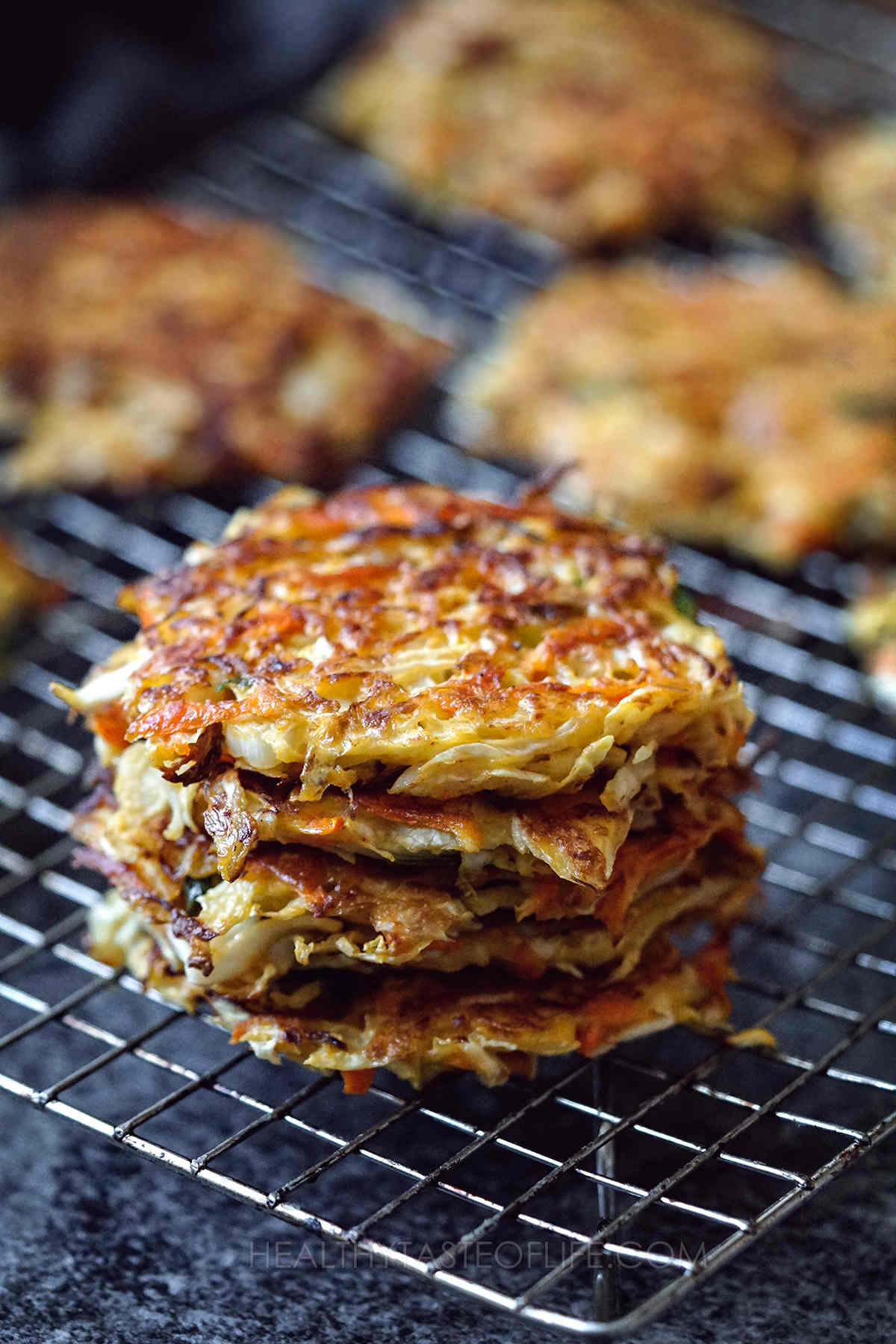 Cabbage fritters, cabbage pancakes or cabbage patties staked on a rack  - close up shot.