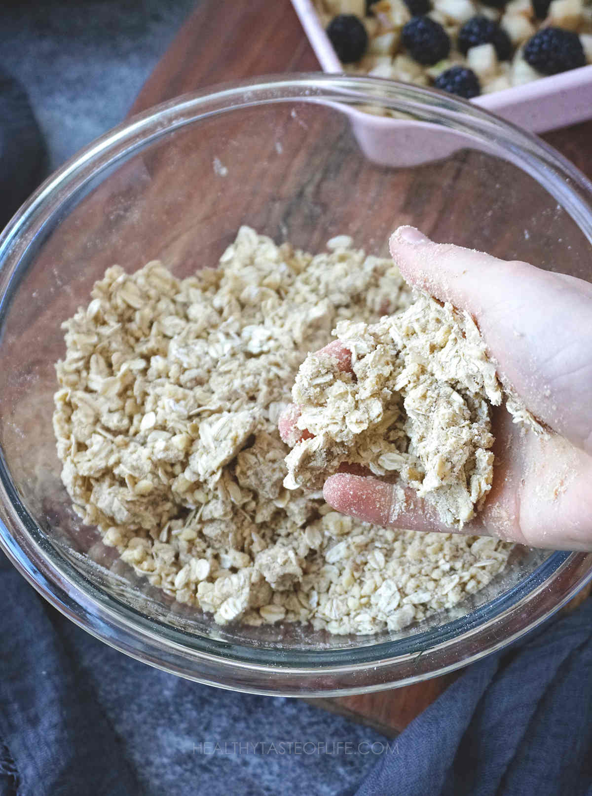 Making clumpy oat crumb topping.