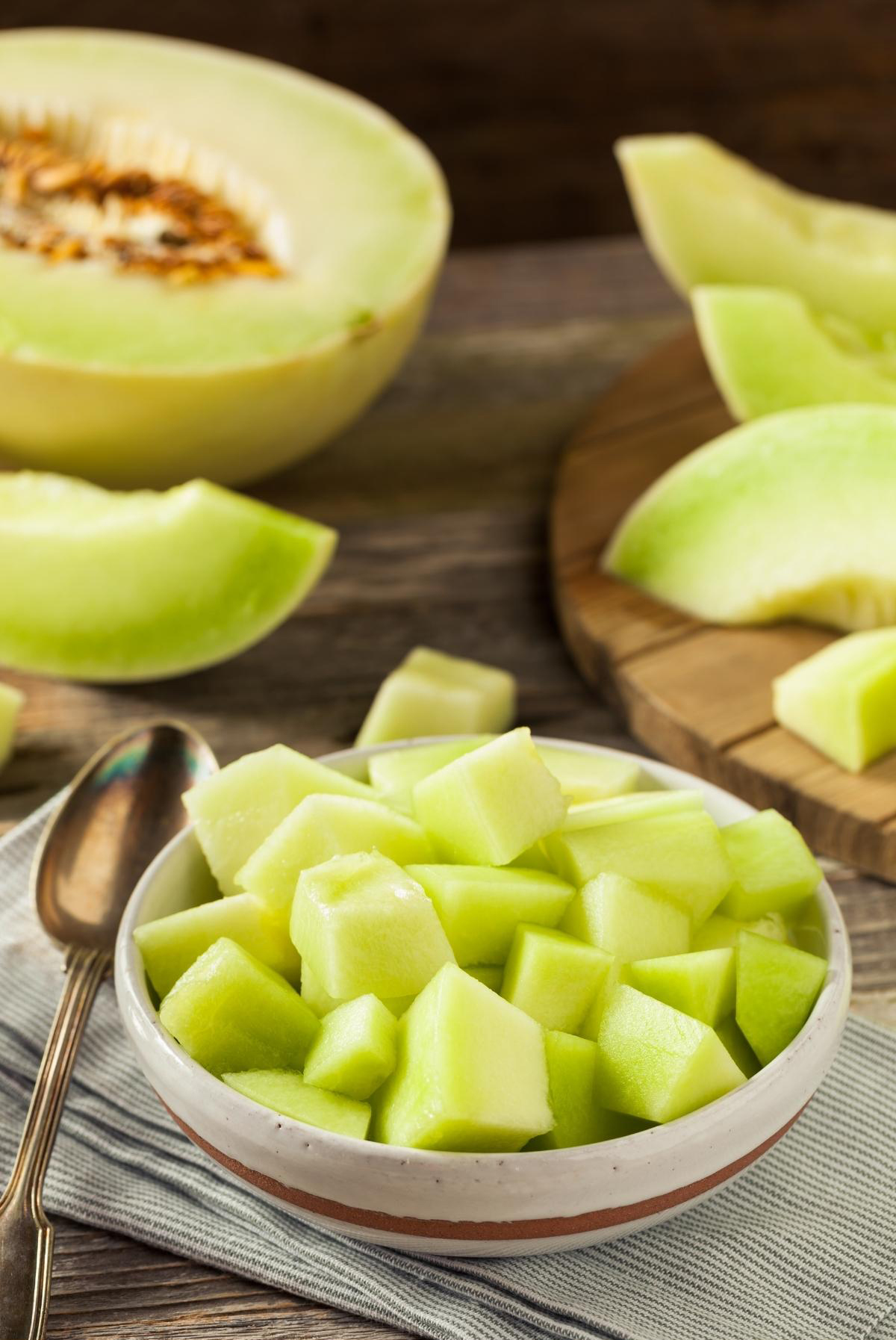 Honeydew melon peeled and chopped in a bowl, ready to be used for smoothie.