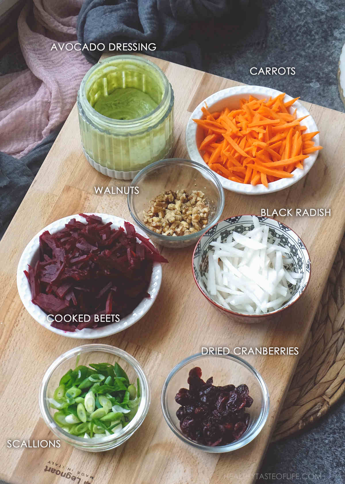 Ingredients for beet carrot salad displayed on a board.