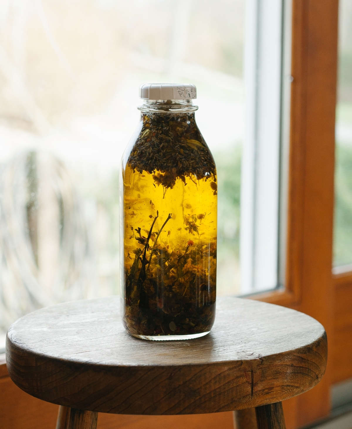 Infusing herbs in oil for natural face moisturizer (DIY).