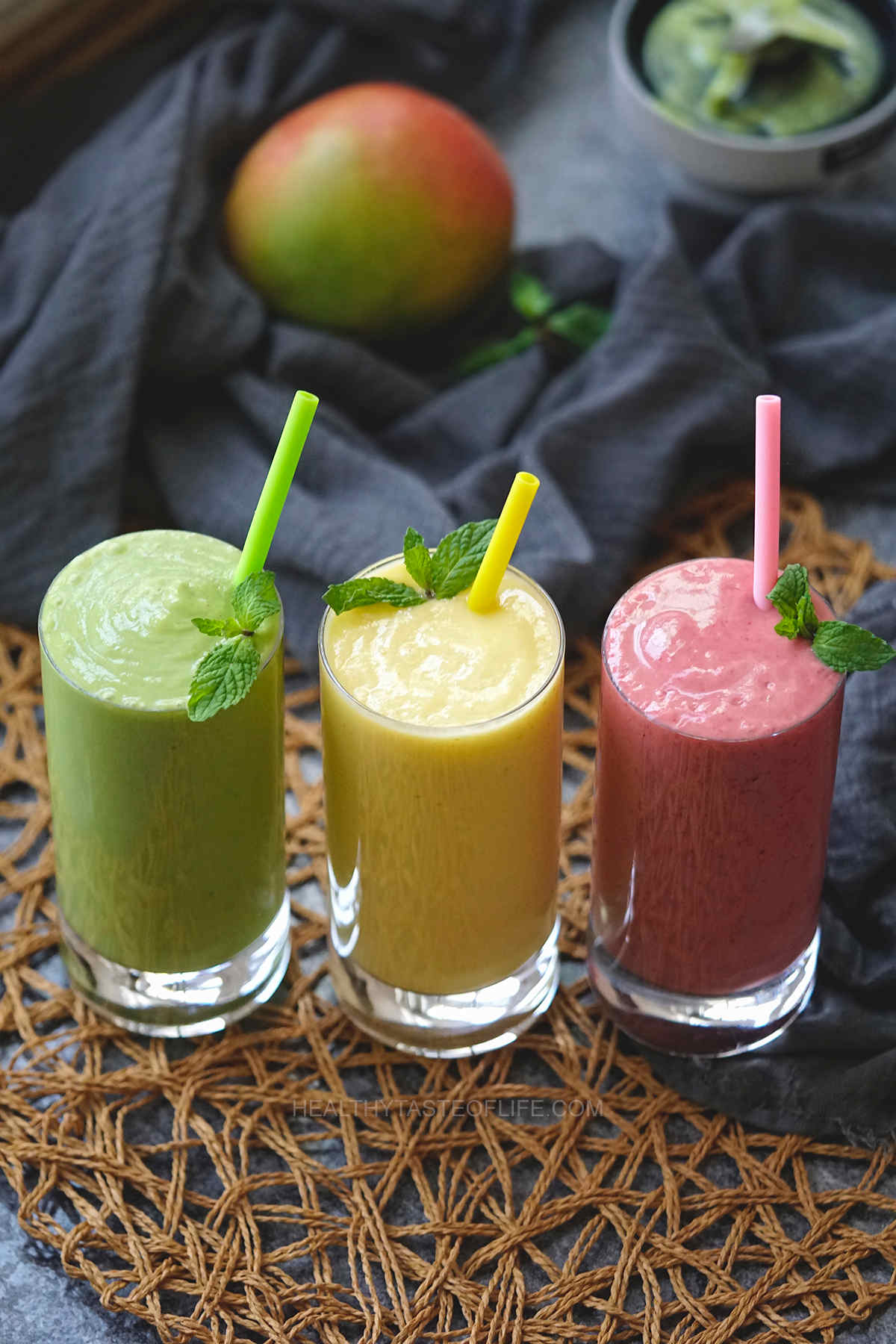 3 ways to make a mango pineapple smoothie: green (leafy greens like spinach), simple and pink with strawberry and blackberry.