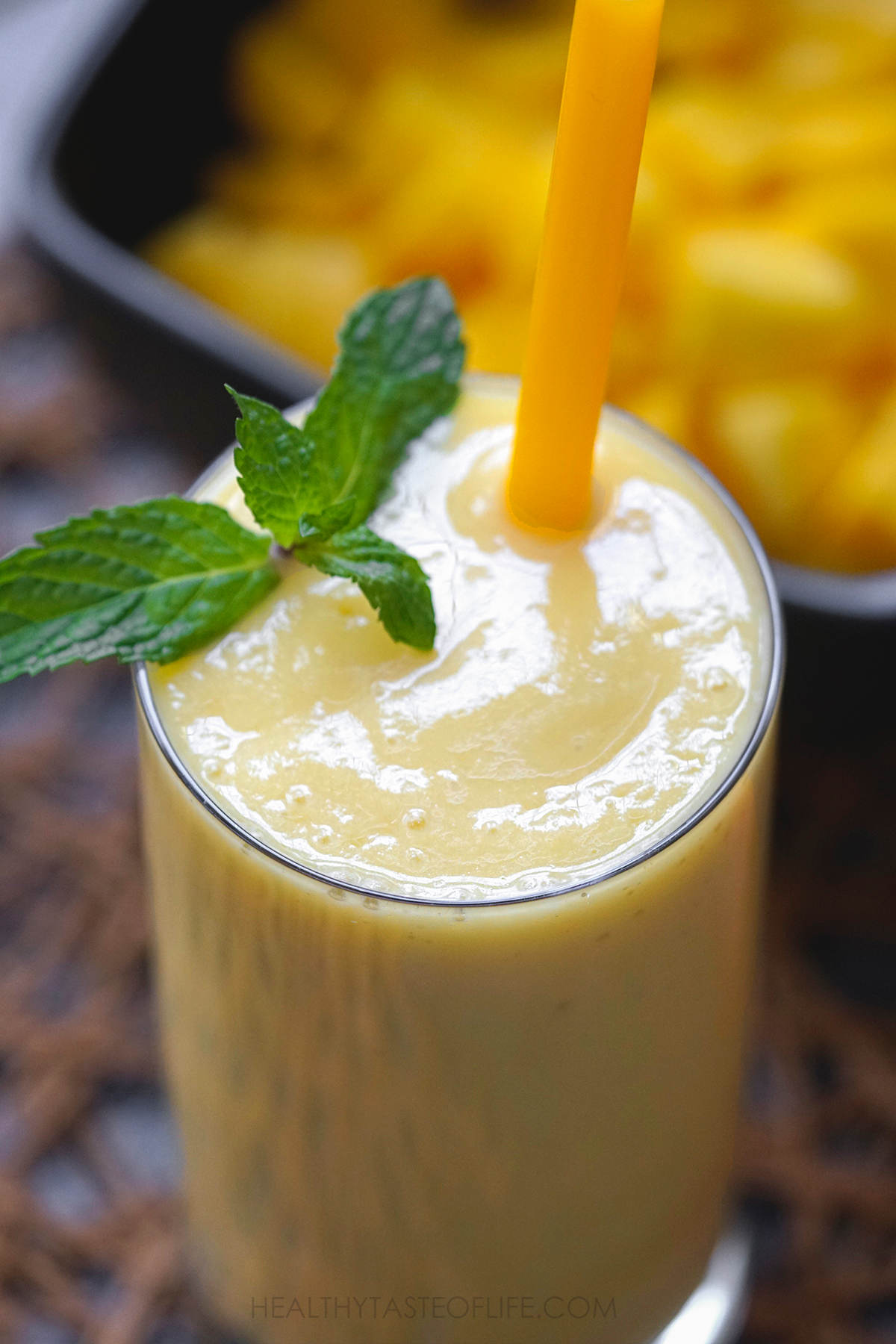 Mango pineapple smoothie close up shot.