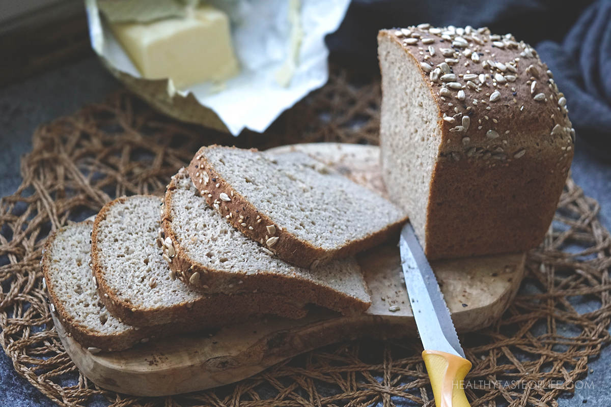 Slices of soft pliable buckwheat flour bread topped with sunflower seeds and sesame seeds.