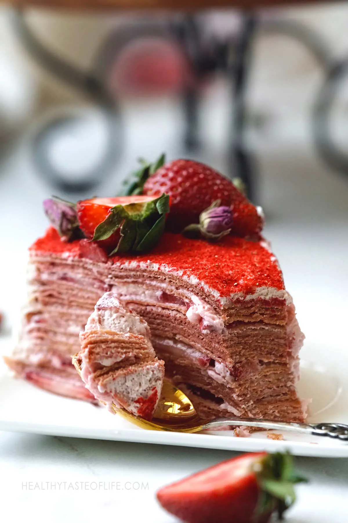 A slice of moist strawberry crepe cake.