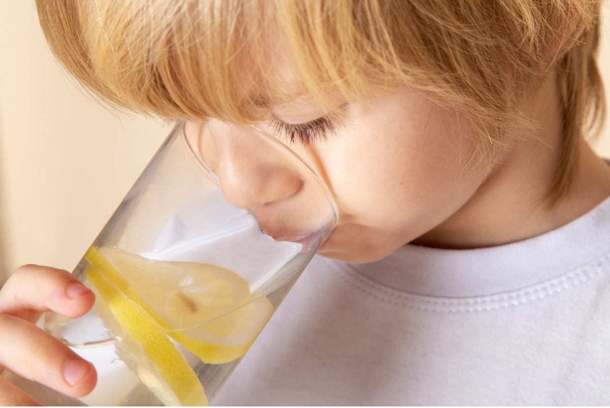 Toddler drinking lemon water as Natural Cold Remedies For Toddlers And Older Kids.