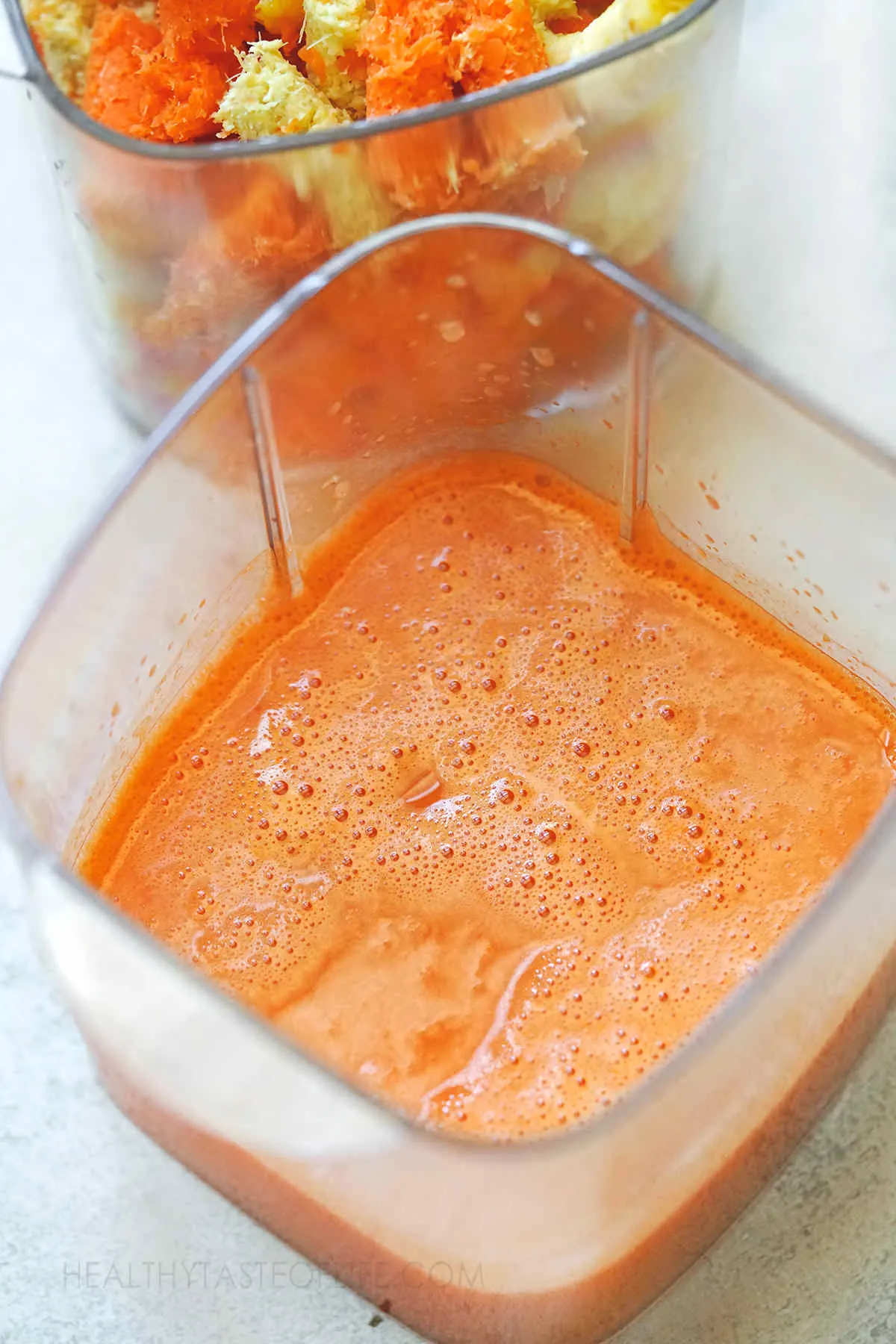 Fresh cold pressed orange ginger carrot juice.