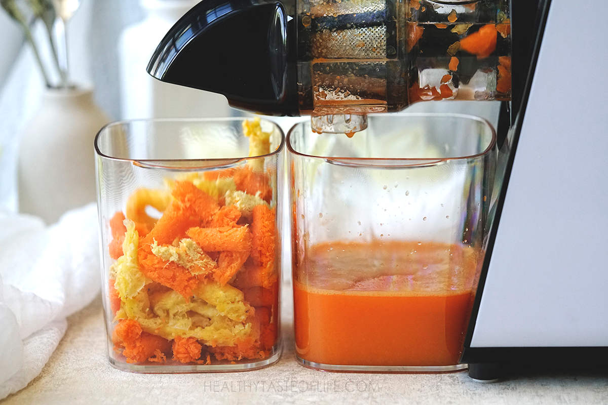 Juicing carrots orange and ginger with a cold pressed masticating juicer.