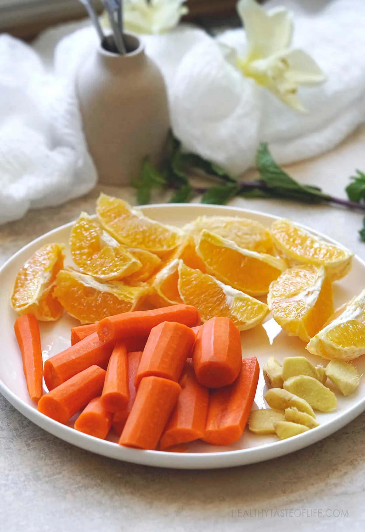 Peeled and chopped carrots, oranges and ginger slices.