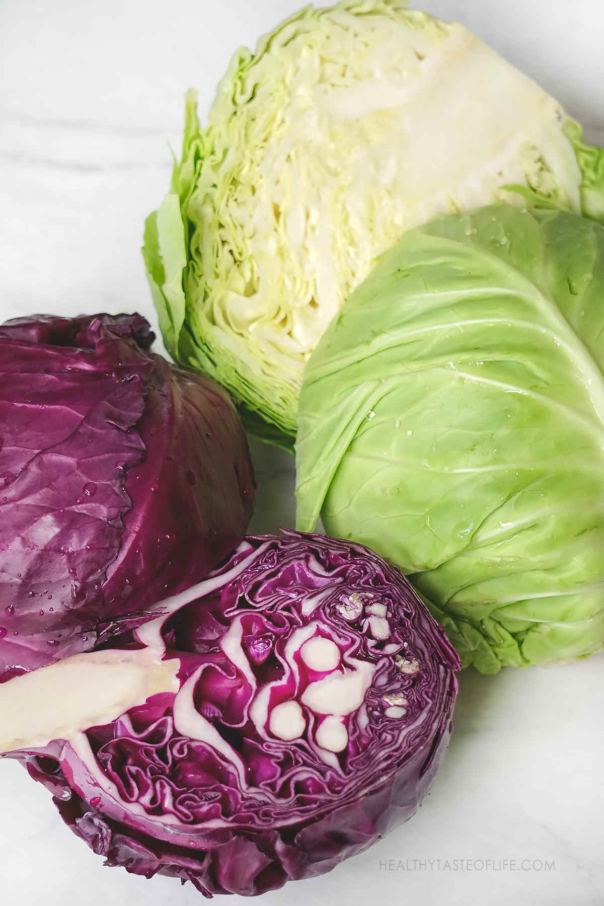 Fresh green and purple cabbage ready to be shredded to make a healthy coleslaw.